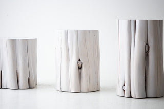 Natural wood grain and character cracking on a whitewash stump table