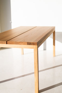 Modern luxury white oak dining table shown in side profile