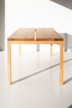 Modern luxury split panel white oak table styled as a desk