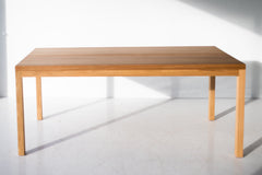 Modern luxury white oak dining table styled in a bright dining room