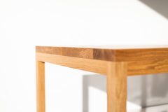 Modern luxury white oak dining table shown from the side
