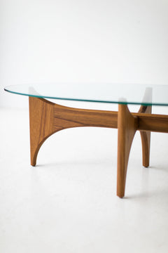 Oval teak coffee table styled in a living room