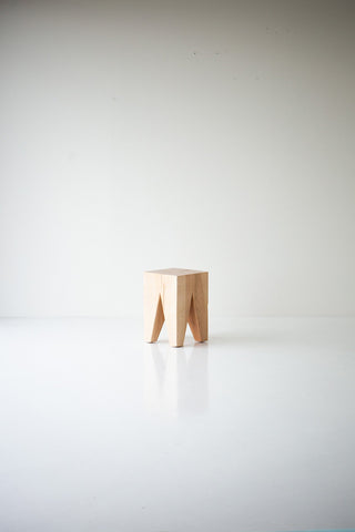 Natural maple Vega stool in a bright room