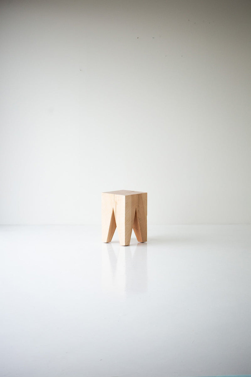 Natural maple Vega stool in a bright room