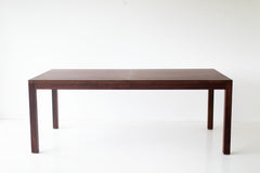Modern walnut dining table with clean tapered legs and an extendable top