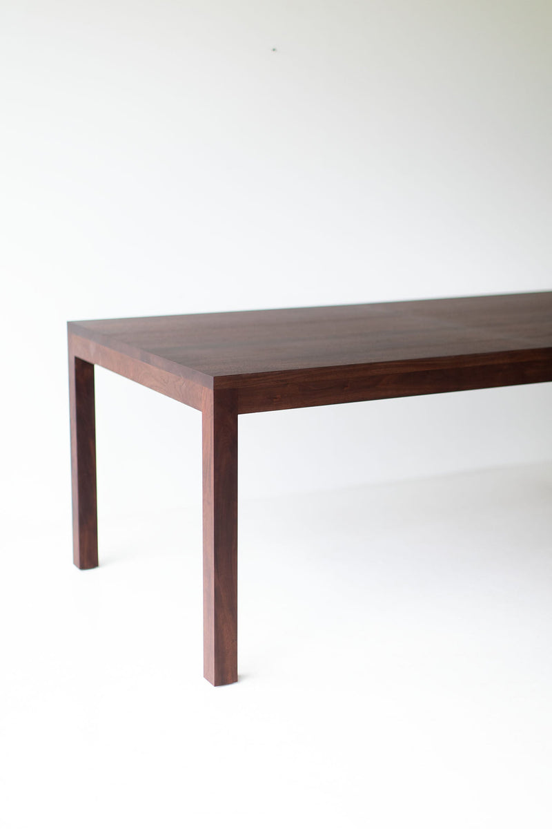 Detail of the tapered wood legs on the walnut dining table