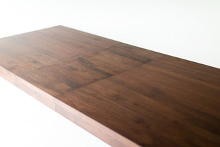 Walnut dining table shown fully extended with leaves added