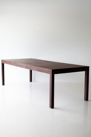 Angled view of the walnut dining table showcasing its proportions