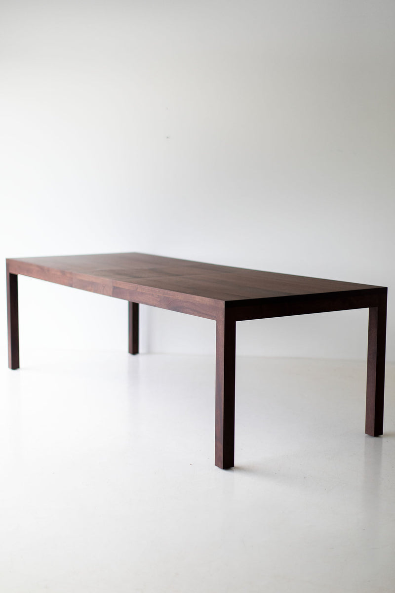 Angled view of the walnut dining table showcasing its proportions