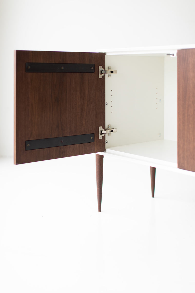 Detail of the door hardware and hand joinery on the modern luxury walnut Cambre credenza