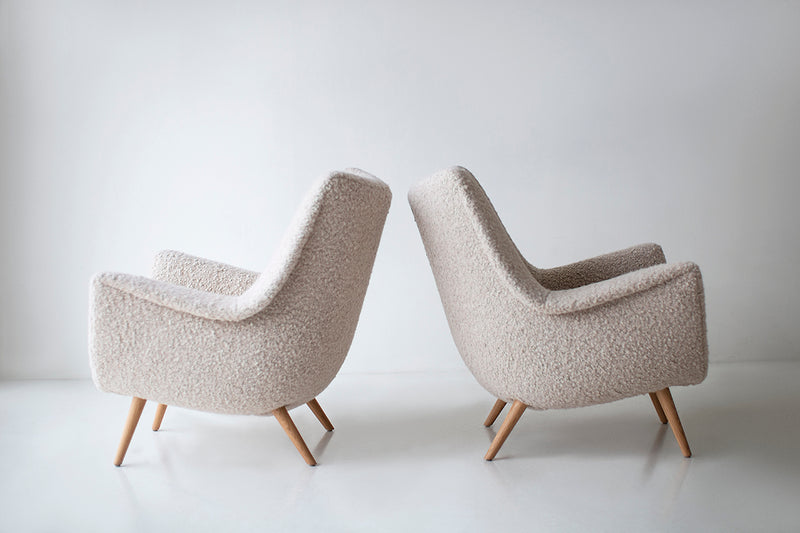 Front view of a Danish lounge chair showing its oak frame and bouclé upholstery