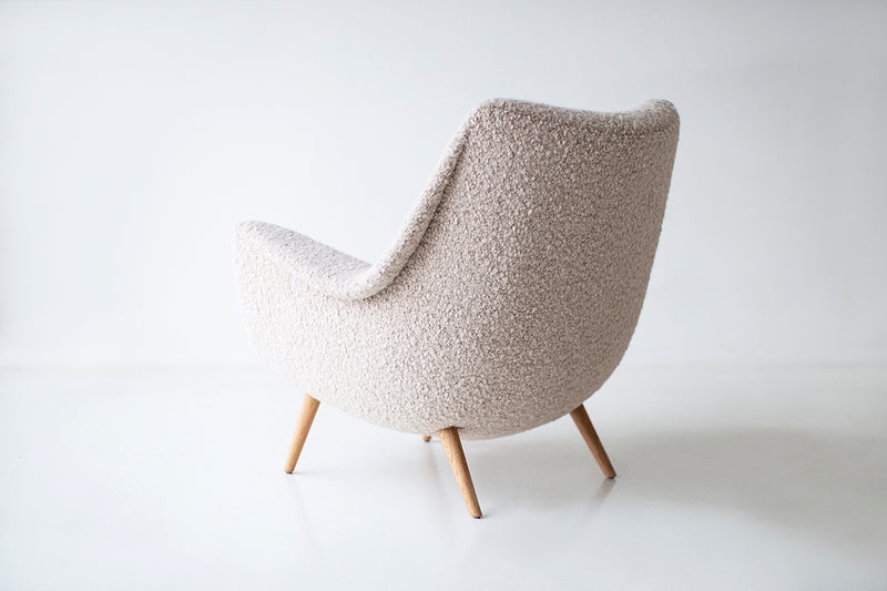 Side profile of a Lawrence Peabody lounge chair highlighting its walnut base