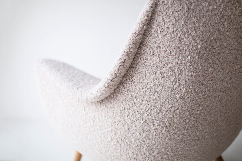 Close-up of the bouclé fabric texture on a Danish modern lounge chair
