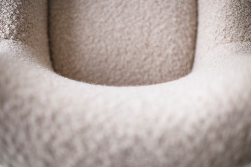 Detail of the walnut base and hand-shaped legs on a lounge chair