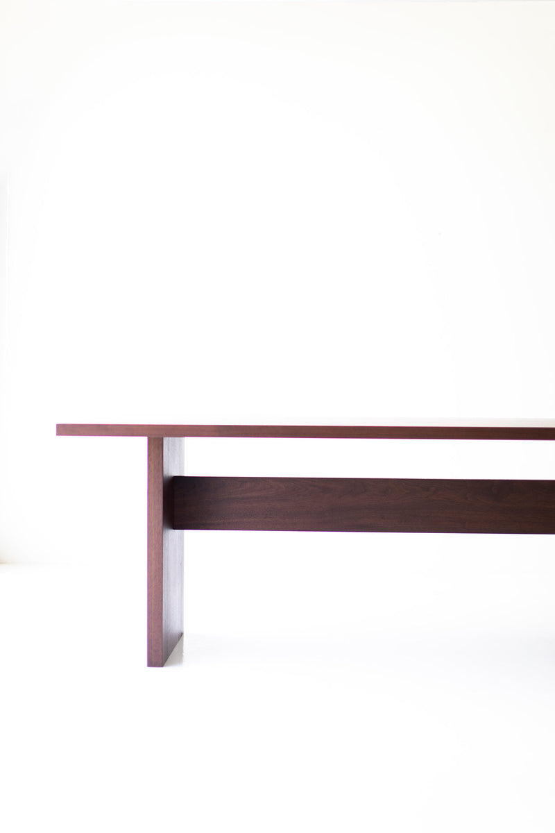 Angled view of the Toko modern walnut table