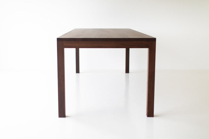 Modern luxury walnut dining table styled with place settings