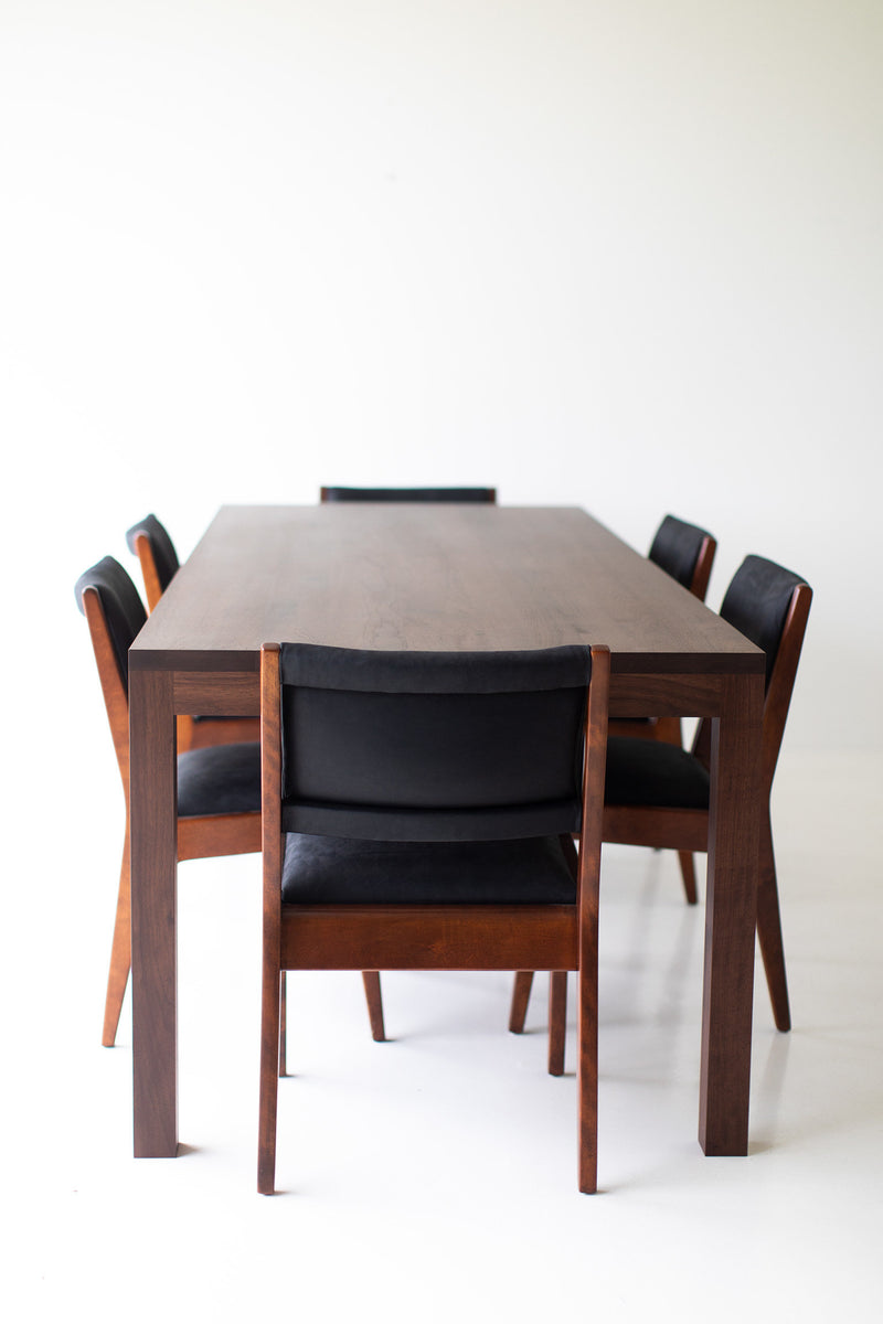 Modern luxury walnut dining table styled as a desk