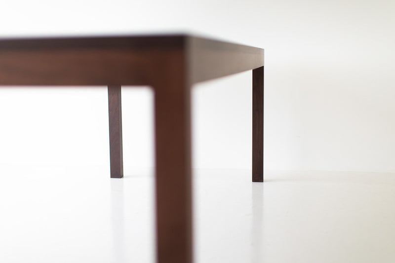 Modern walnut dining table, close-up of the legs and base