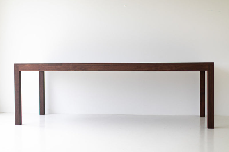 The Christopher modern luxury walnut dining table in a styled dining room