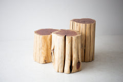 Natural red cedar stump side table shown at an angle