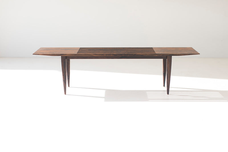 Side profile of the modern slatted J Bench in ziricote