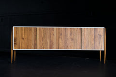 Detail of the lacquered maple frame and teak legs on the modern luxury Cambre credenza