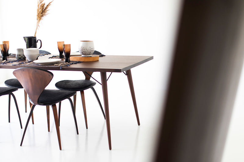 Modern luxury New York dining table shown with chairs around it