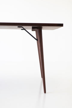 Angled detail of the modern luxury New York walnut dining table