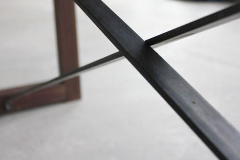 Modern walnut dining table styled as a luxury home-office desk