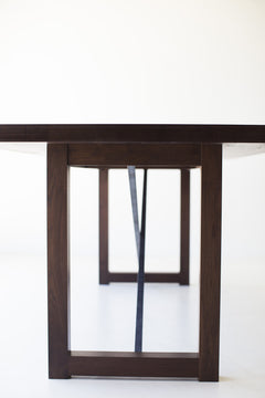 Close-up of the hand-perfected matte finish on the modern walnut tabletop