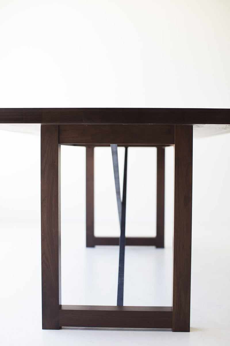 Close-up of the hand-perfected matte finish on the modern walnut tabletop