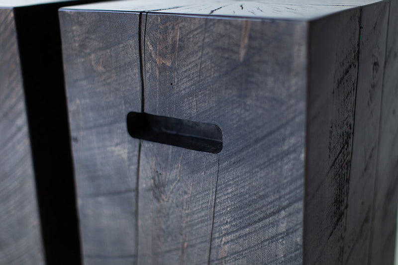 Close-up of the natural wood grain and cracking on the side table with cutouts