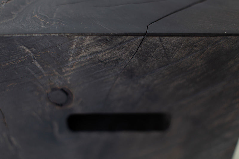 Detail shot of a cutout handle on the wood side table