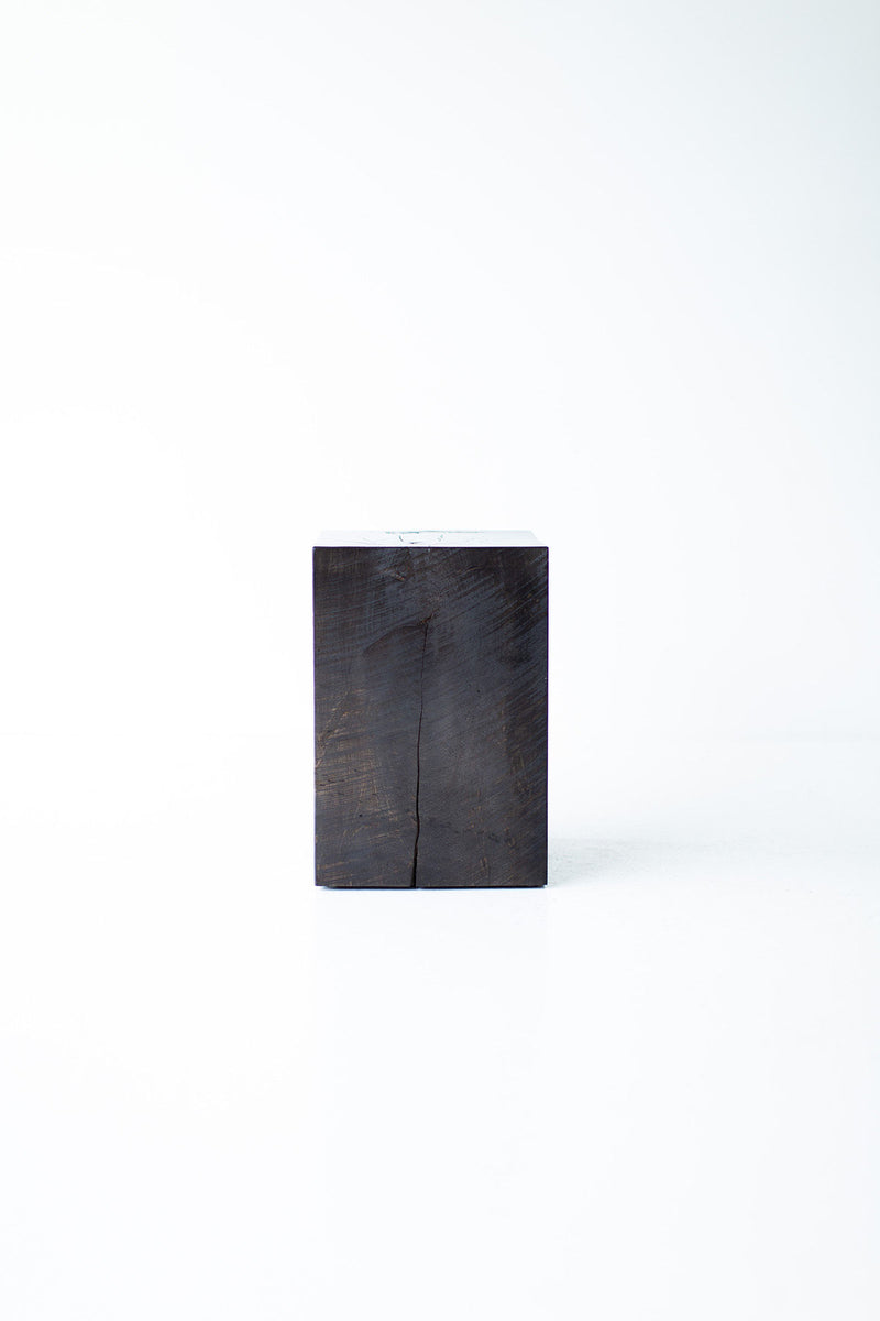 Three modern wood side tables with cutouts grouped together at different heights