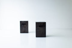 Full view of the modern wood side table with cutouts against a neutral backdrop