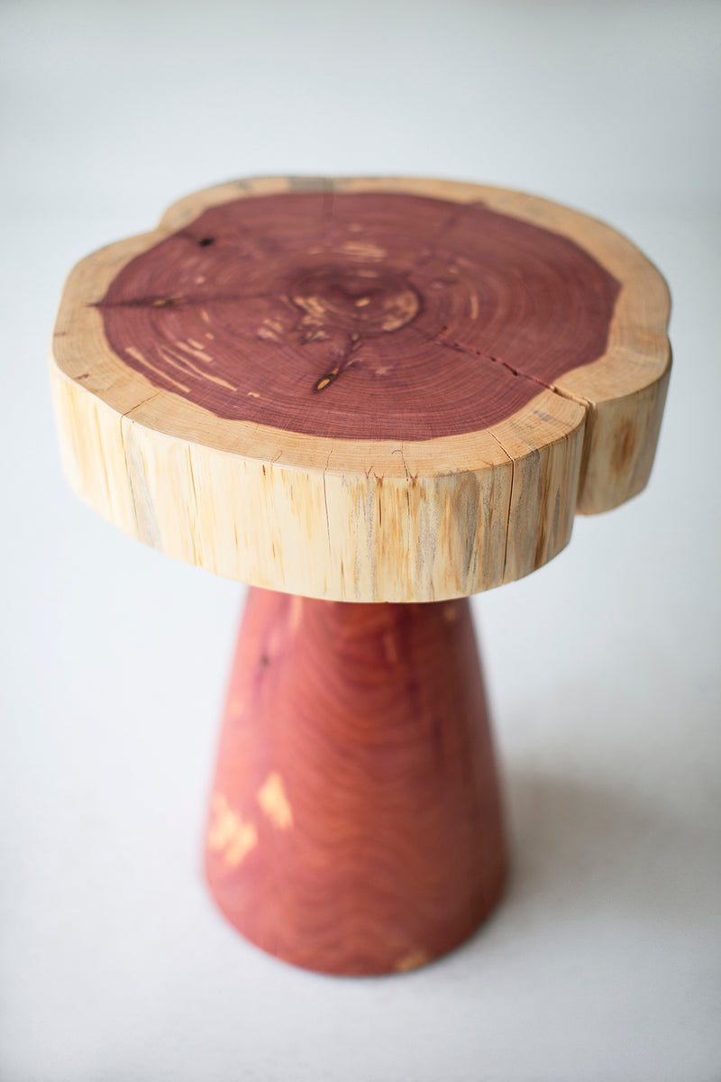 Side profile of a whitewash red cedar stump table highlighting its natural form