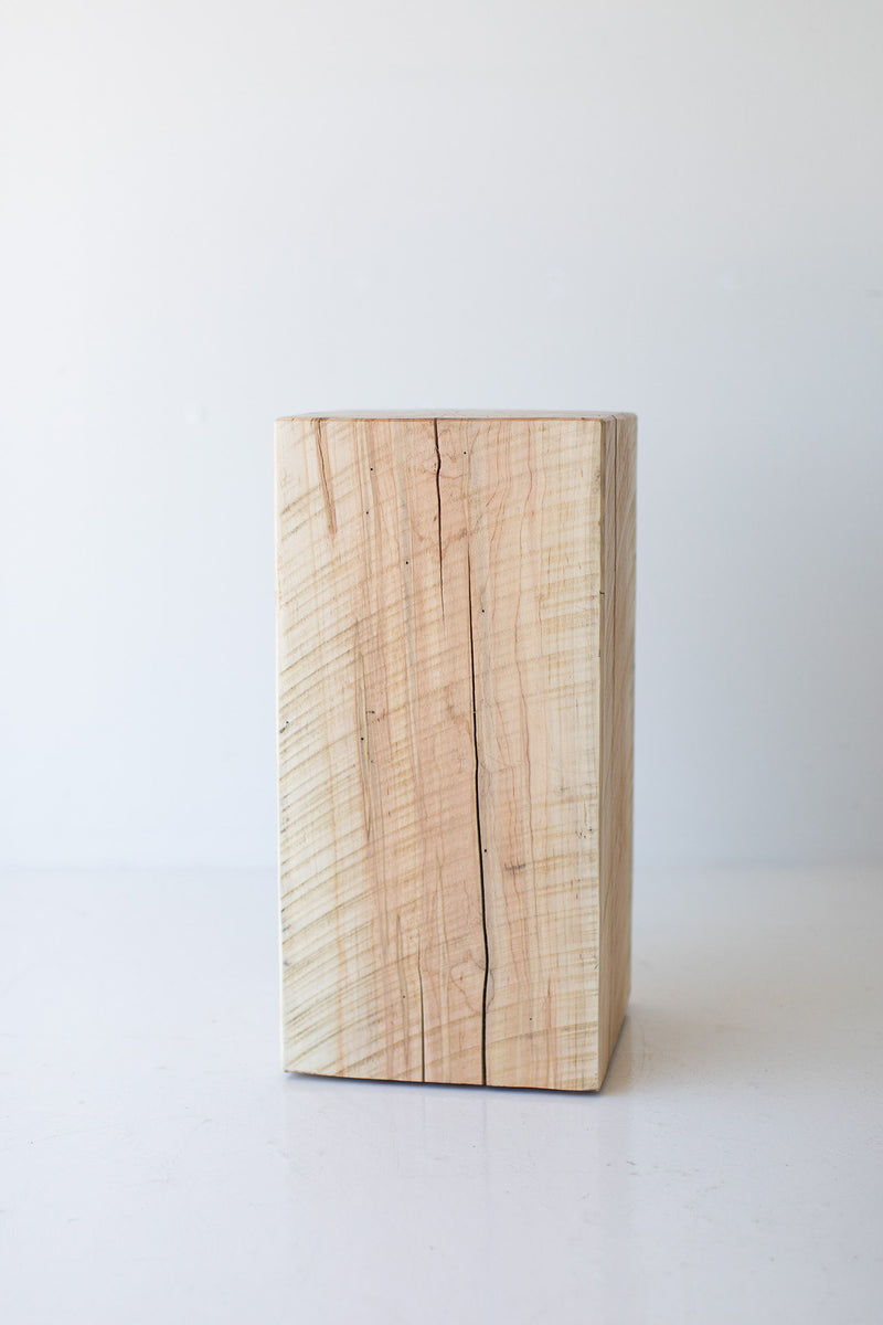 Detail shot of the tree stump table's bark-edged rim and natural imperfections