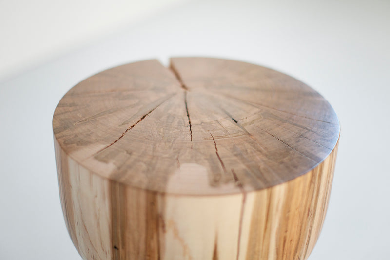 Angled view of a maple counter stool showing its hand sawed edges