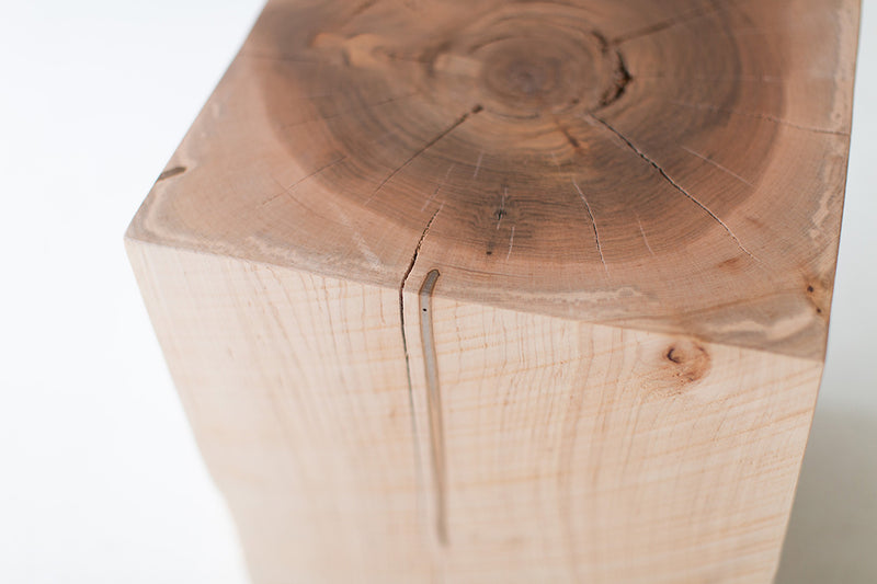 Close-up of the natural maple grain and crack on the end table's square top