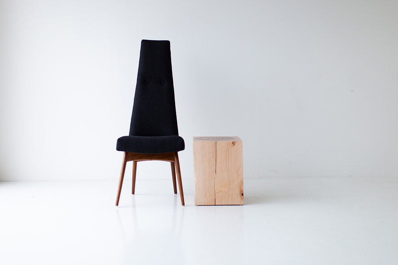 Natural maple block end table beside a black upholstered chair