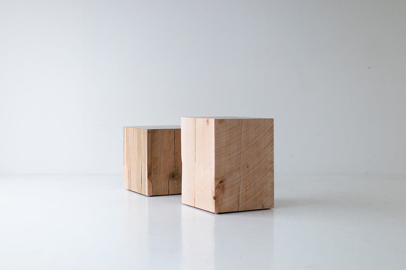 Two natural maple block end tables at a distance