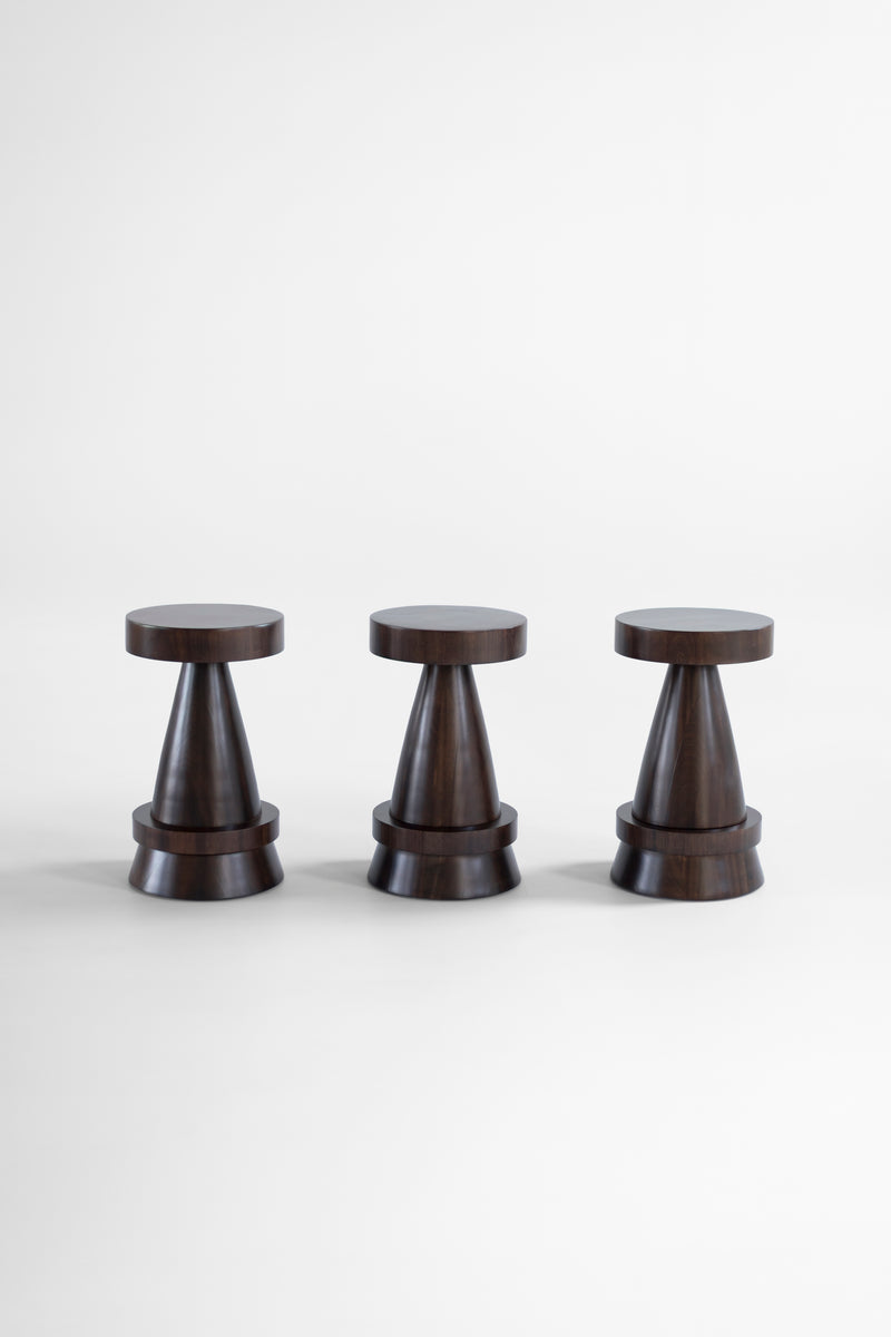 The Outdoor Boca counter stool in exterior walnut finish in a sunlit outdoor living space.