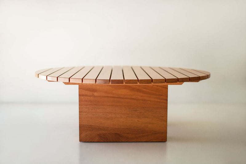 Front view of a Suelo outdoor coffee table showing its sleek round top