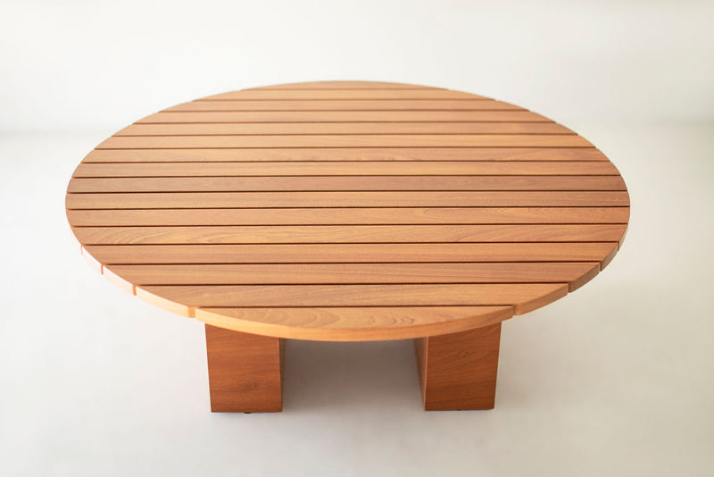 Side profile of a round wood coffee table highlighting its low profile