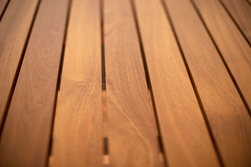 Angled view of an outdoor Suelo coffee table showing its solid wood base