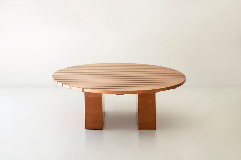 Round Suelo coffee table styled on a patio with outdoor seating
