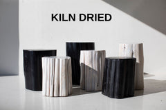 Black and whitewash outdoor red cedar stump tables grouped together