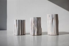 Three whitewash outdoor stump tables in sunlight