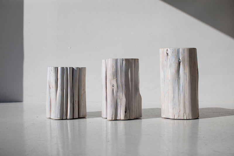 Three whitewash outdoor stump tables in sunlight