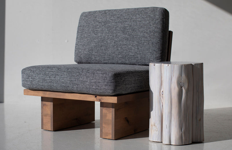Whitewash outdoor stump table beside a lounge chair